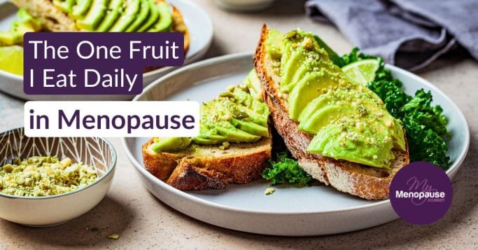 Midlife woman slicing a ripe avocado in her kitchen