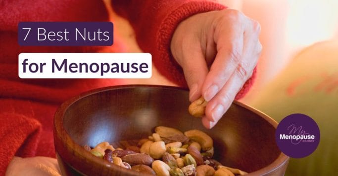 Midlife woman enjoying a handful of mixed nuts in her kitchen — best nuts for menopause
