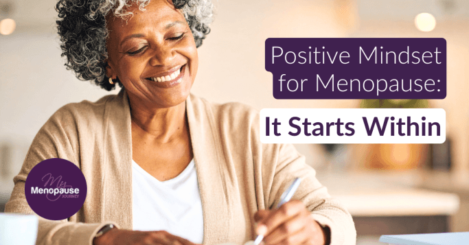 Smiling midlife woman by a sunlit window — embracing a positive mindset in menopause