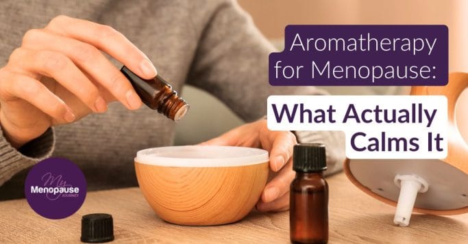 Midlife woman holding a small amber bottle of lavender oil in her kitchen — aromatherapy for menopause
