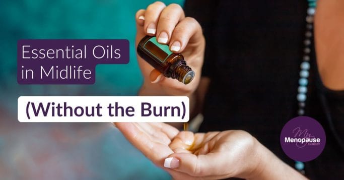 Midlife woman holding a small amber bottle of essential oil at her kitchen counter — how to use essential oils for menopause