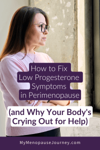 Pink-sweater woman pausing at the window &mdash; signs of low progesterone symptoms in perimenopause