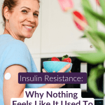 Smiling midlife woman in her kitchen holding strawberries with a glucose monitor on her arm &mdash; insulin resistance in women