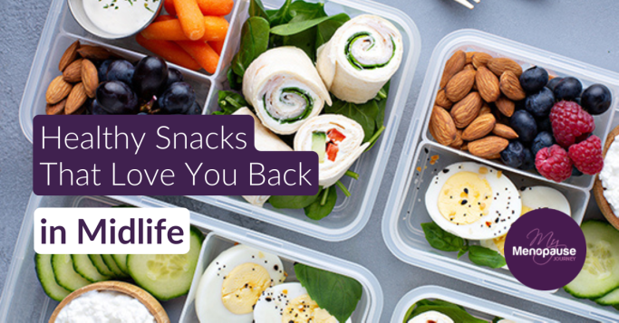 Meal-prep boxes filled with healthy snacks for menopause — almonds, blueberries, raspberries, boiled eggs, veggie wraps, carrots and cucumber