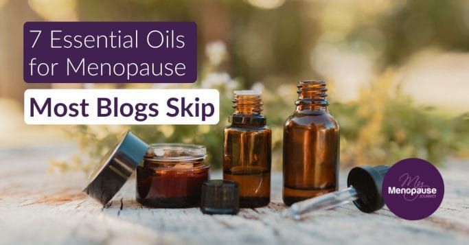 Collection of amber essential oil bottles on a wooden surface — essential oils for menopause
