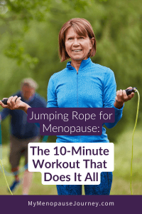 Smiling midlife woman in a blue jacket holding jump rope handles outdoors &mdash; jumping rope for menopause