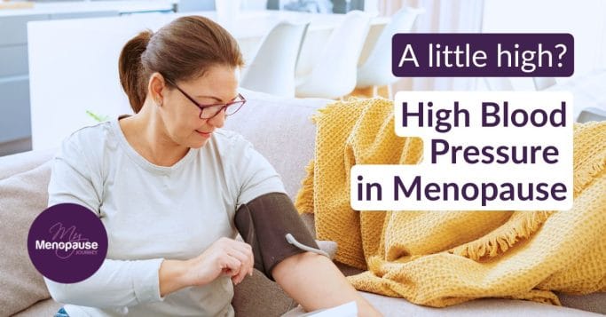Midlife woman checking her blood pressure at home with a monitor