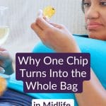 Midlife woman on the couch with chips and a glass of wine — emotional eating in menopause