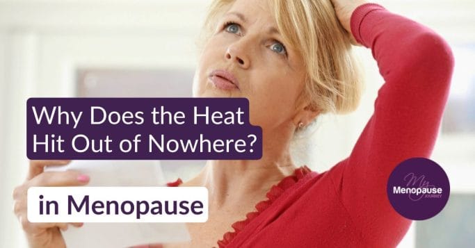 Midlife woman in a red top fanning herself with a paper during hot flashes
