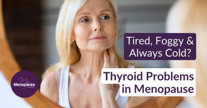 Midlife woman gently touching her neck in the mirror, wondering about thyroid problems